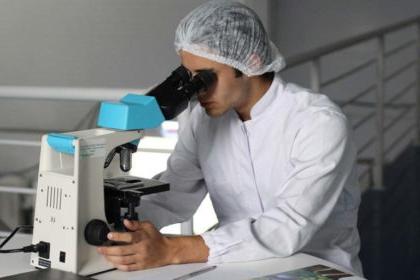student at microscope